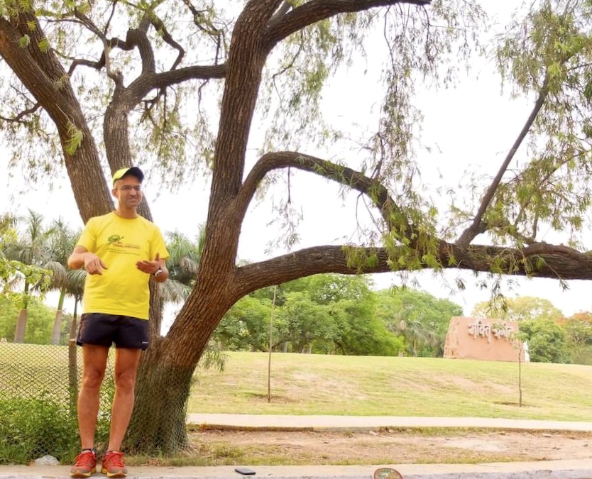 Dr. Rajat Chauhan speaking under a tree in a park